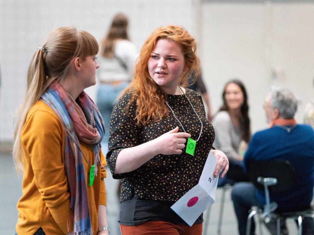 Participants walking in a large circle in conversation, project The Polarity Party. Photo: Dirk Rose