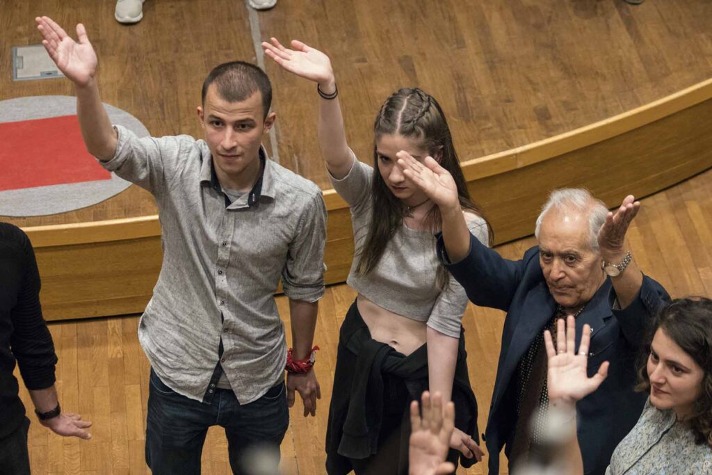 Group of participants in The Exchange raising their arms, Ankara. Photo Mert Oener