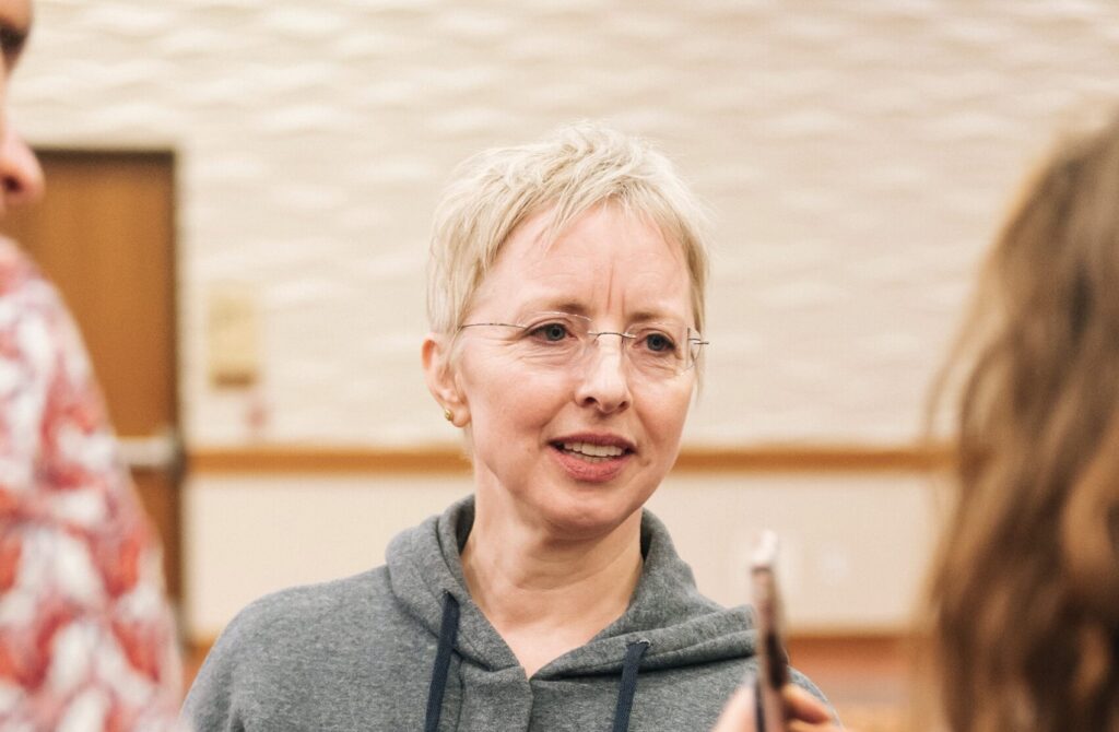 Dana Caspersen standing with workshop participants